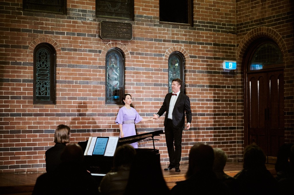 Aleta Shang bowing on stage with the pianist